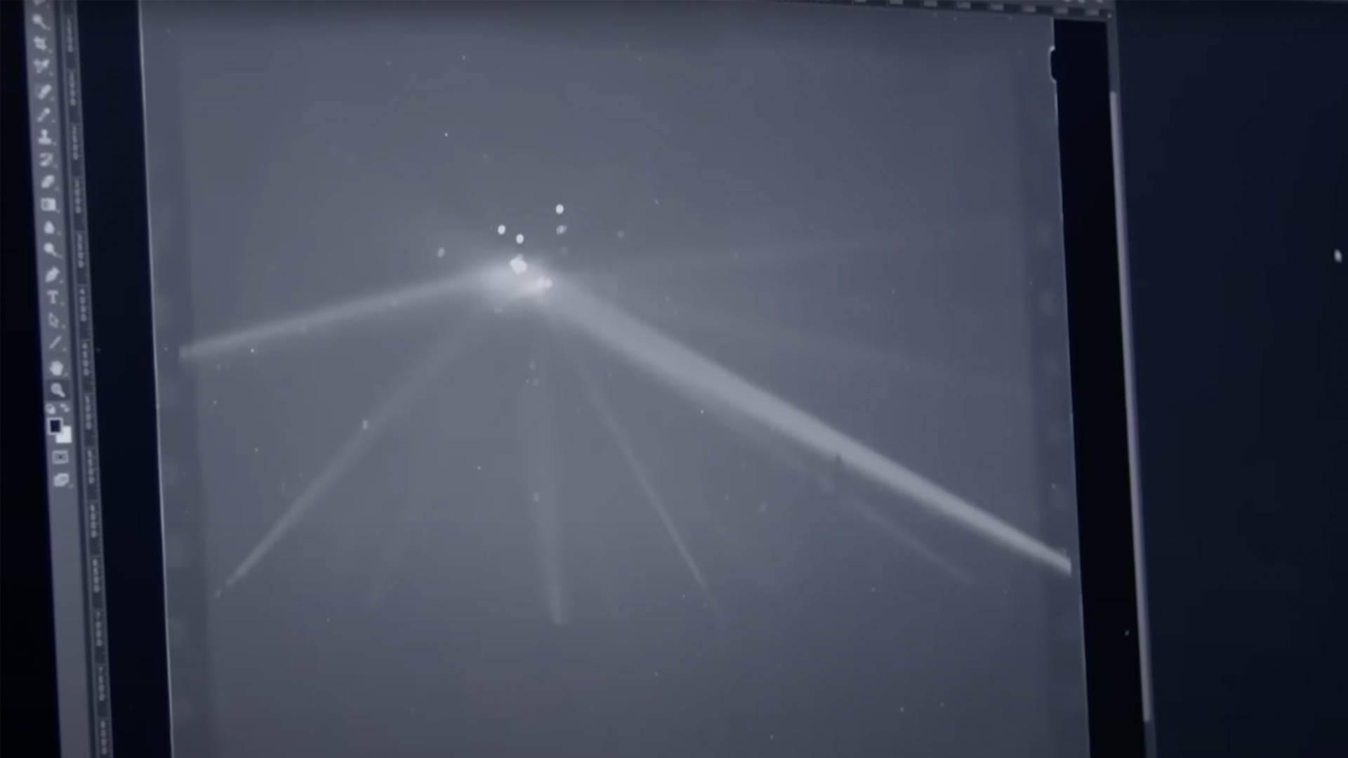 Computer screen showing an old photo of spotlights on a potential UFO