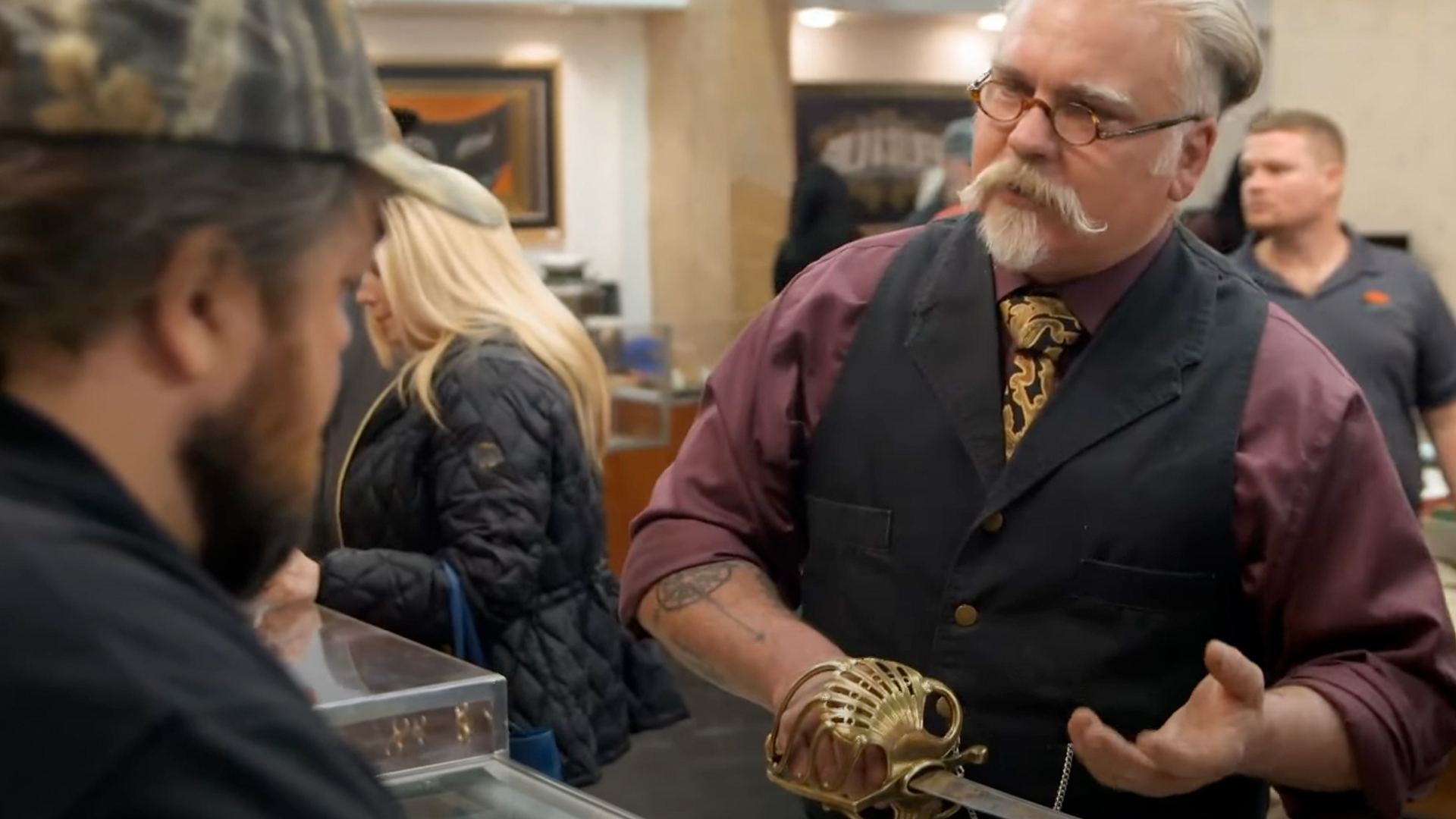 Dave Baker speaking to Chumlee while holding a Napoleonic sword