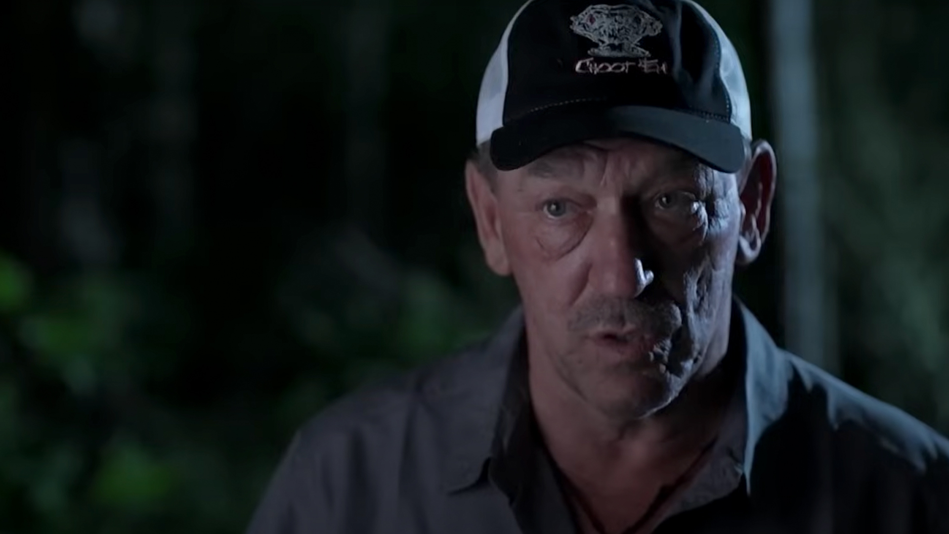 Troy Landry in a dark swamp