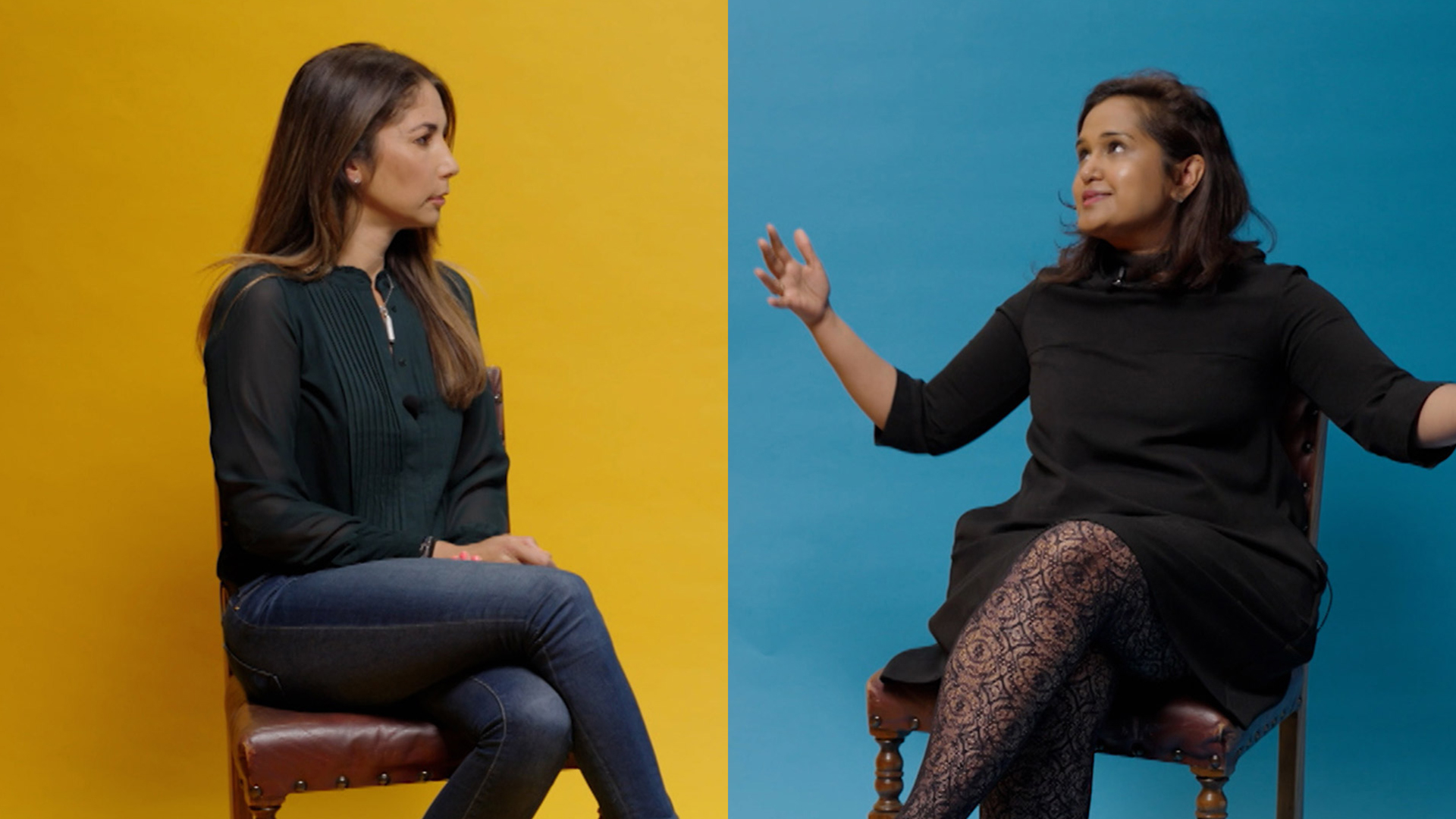 Dr Shumonta Quaderi and Leilani Dowding talk while sitting in front of a background that is split down the middle - yellow on one side and blue on the other