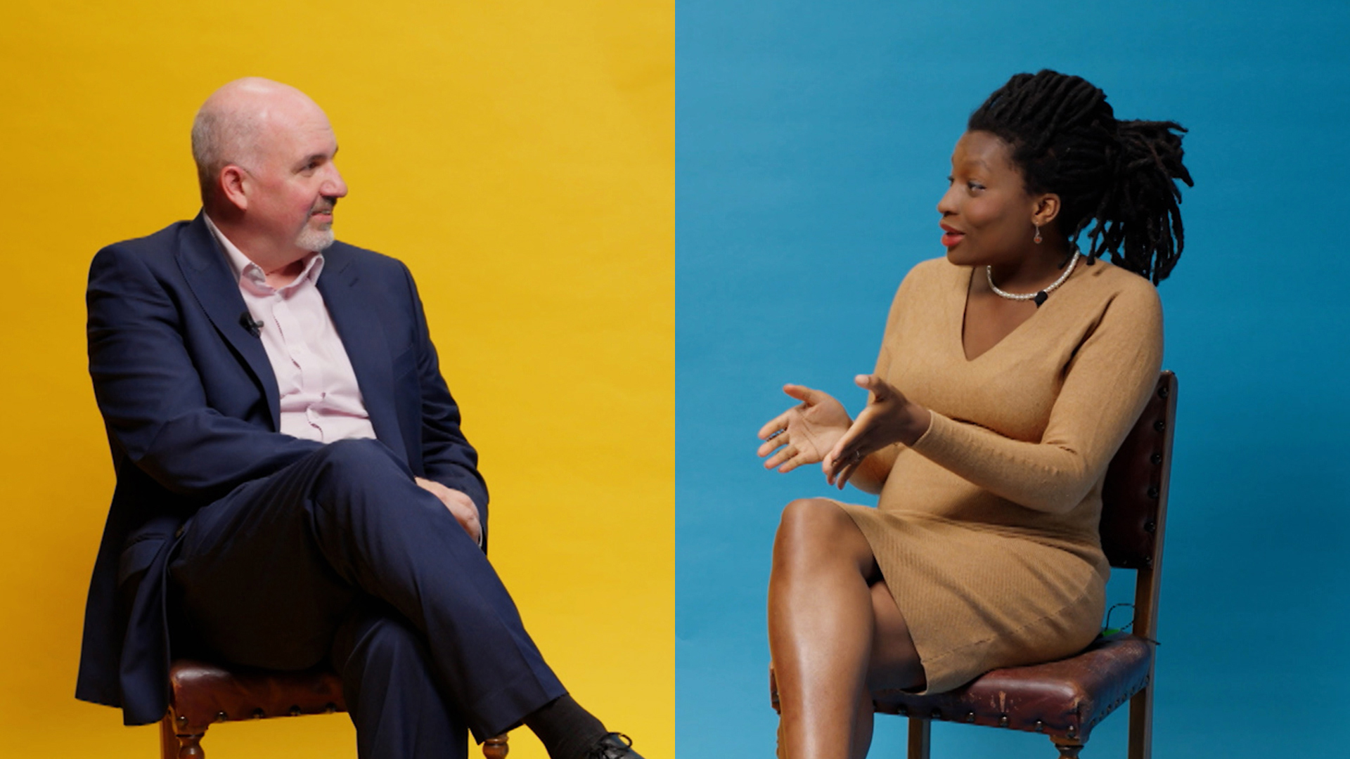 A man and a woman sitting either side of a divided background which is yellow on the left and blue on the right