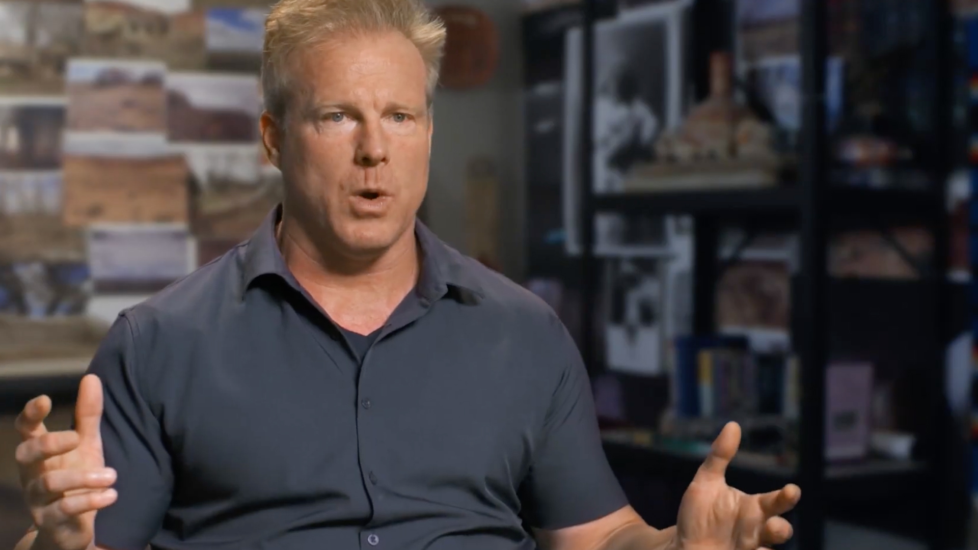 Dr Travis Taylor gesturing with his arms while talking to the camera