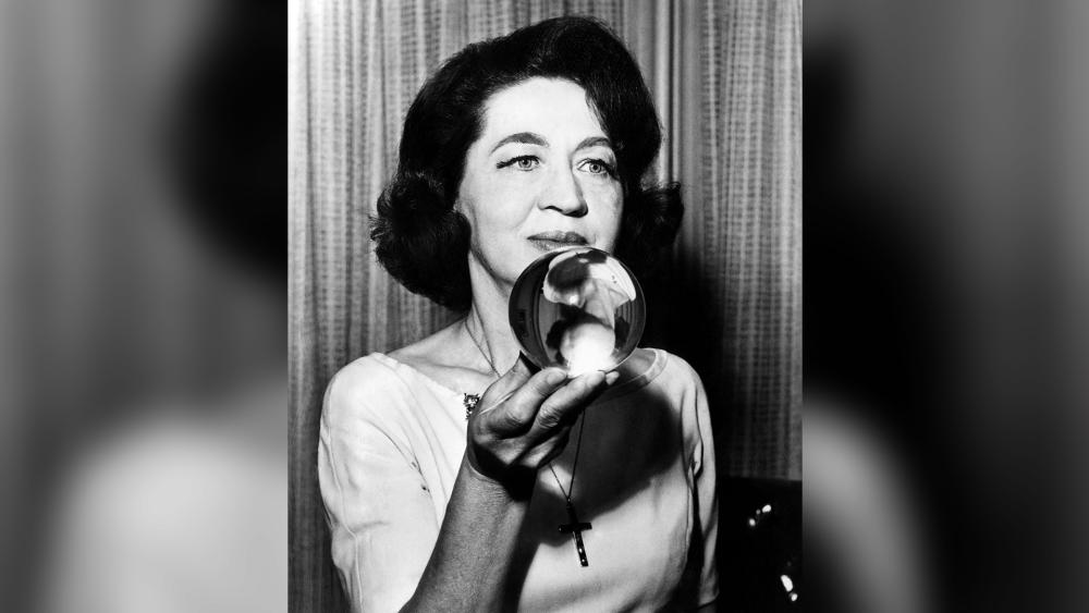 Jeane Dixon holding a crystal ball