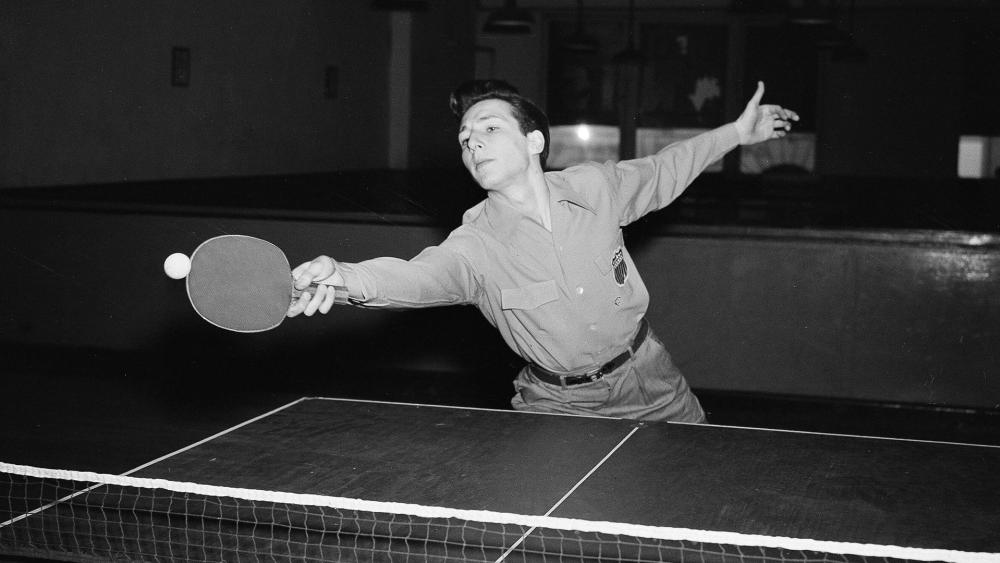 Marty Reisman stretches to hit a ping pong ball