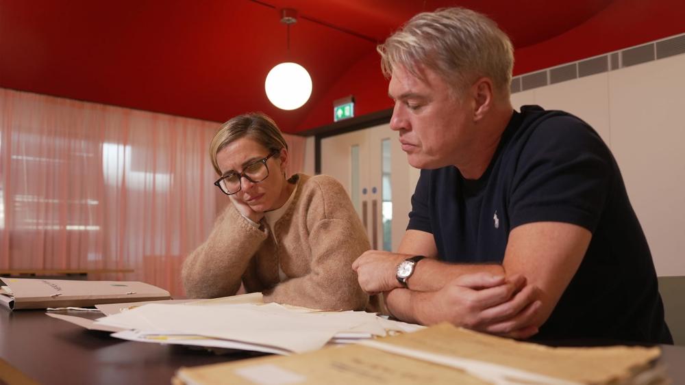 Vicky and Jonny looking at old documents in the National Archives