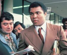 Muhammad Ali signs autographs for fans at the San Antonio International Airport in 1979