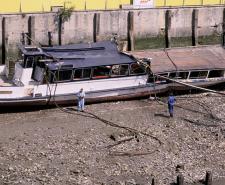The wreck of the Marchioness pleasure boat beached on the bank of the Thames