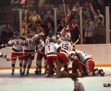 The US hockey team celebrate on the ice after defeating the Soviet Union at the 1980 Winter Olympics