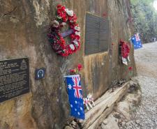 A memorial for Allied POWs at the Hellfire Pass. Poppies, plaques and Australian flags are mouted on the side of a rock in the jungle
