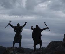 Two Scandinavian Viking warriors in full armor against dramatic landscape