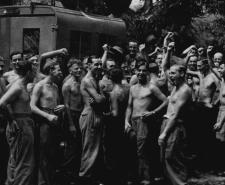 Black and white photograph of British troops in Burma celebrating after hearing the news of the Japanese surrender
