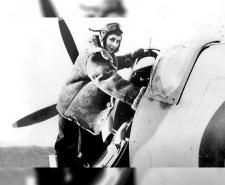 Black and white photograph of pilot Diana Barnato Walker climbing into the cockpit of a Spitfire
