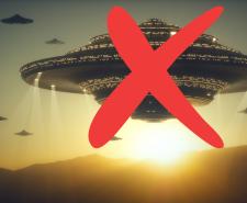 Large UFOs hover above mountains at sunset with a big red X drawn over the scene.