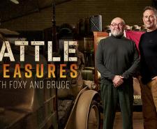 Bruce Crompton and Jason Fox stand next to each other in front of military artefacts