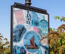 Sign for Manningtree in Essex which includes an illustration of Matthew Hopkins
