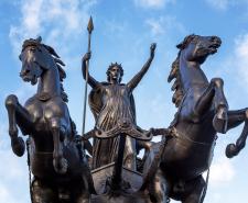 Statue of Boudica on her chariot with two horses rearing on their hind legs