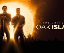 Rick and Marty Lagina hold shovels while standing in front of a glowing golden coin