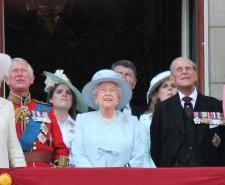 Members of the royal family, including Queen Elizabeth II, Prince Philip, King Charles III, Queen Camilla and Catherine, Princess of Wales stand of the balcony of Buckingham Palace and look at the sky