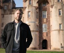 Rick Edwards standing in front of Fyvie Castle