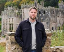 Rick Edwards standing in front of Gwrych Castle