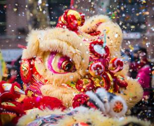 Confetti fills the air during a lion dance celebration during Chinese New Year