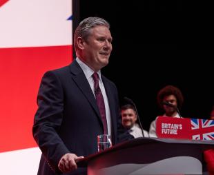 Sir Keir Starmer speaks at the Labour Party Conference in October 2023 while standing at a podium that says, 'Britain's Future'