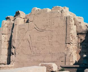 Bas-Relief of Pharaoh Thutmose III smiting and killing Canaanite enemies at the Battle of Megiddo on the Seventh Pylon in Karnak Temple