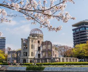 The Hiroshima Peace Memorial in the 21st century with cherry blossoms in the foreground