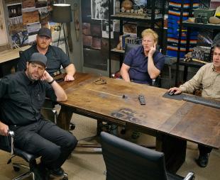 (From L-R) Bryant ‘Dragon’ Arnold, Kaleb Bench, Dr Travis Taylor and Erik Bard sitting around a large table looking at something on the wall