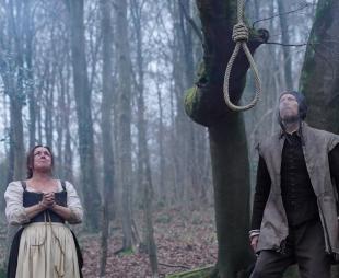 Dramatic reconstruction of Agnes Waterhouse looking up at a noose