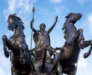 Statue of Boudica on her chariot with two horses rearing on their hind legs