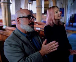 Tony McMahon and Professor Alice Roberts talking inside a church