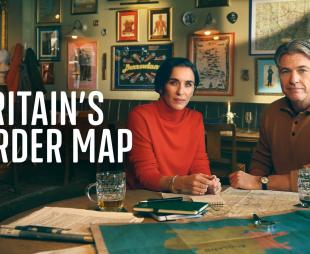 Vicky McClure and Jonny Owen sitting in a pub looking at lots of old maps
