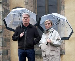 Vicky McClure and Jonny Owen standing together beneath umbrellas