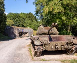 An old tank in front of a military fortification on the Maginot Line
