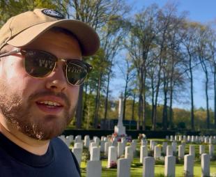 The author, Kyle Jackson, in front of war graves