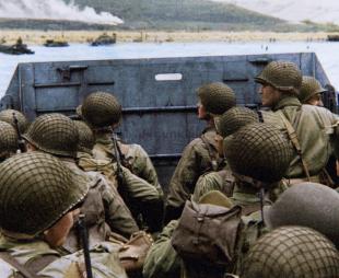 Soldiers aboard a landing craft approach the Normandy beaches during D-Day, depicted in a World War II documentary or drama.