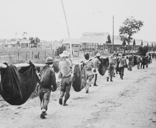 US prisoners using improvised litters to carry those of their comrades who died during the Bataan Death March