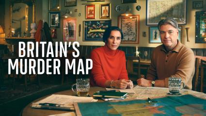 Vicky McClure and Jonny Owen sitting in a pub looking at lots of old maps