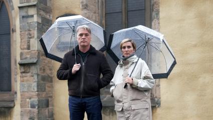 Vicky McClure and Jonny Owen standing together beneath umbrellas