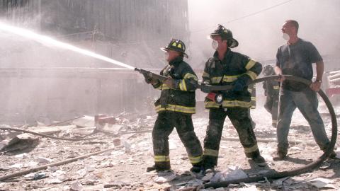 A photo showing New York City firefighters working near the area known as Ground Zero, after the collapse of the Twin Towers on September 11, 2001 in New York City.