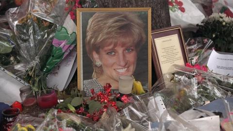 A photograph of Princess Diana surrounded by flowers and notes from mourners following her death