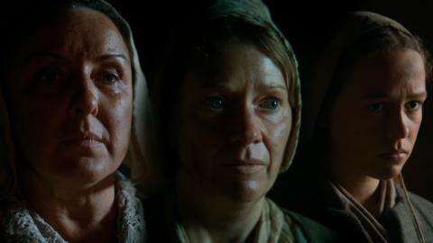 Three female actors portraying 16th and 17th century witches
