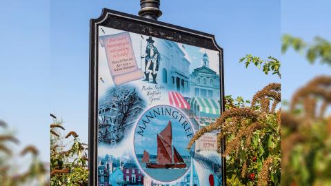 Sign for Manningtree in Essex which includes an illustration of Matthew Hopkins