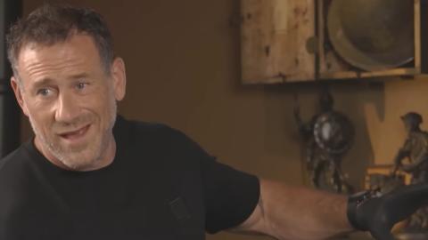 Jason Fox on Battle Treasures pointing with his arm raised and looking at someone off screen