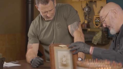 Jason Fox and Bruce Crompton looking at a radio disguised as a picture frame