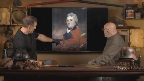 Jason Fox points at a painting of Sir Hildebrand Oakes while Bruce Crompton looks on