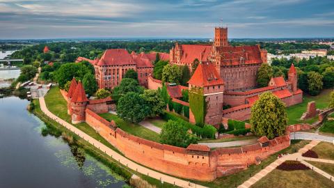 Malbork Castle in Poland made of red brick and next to the river
