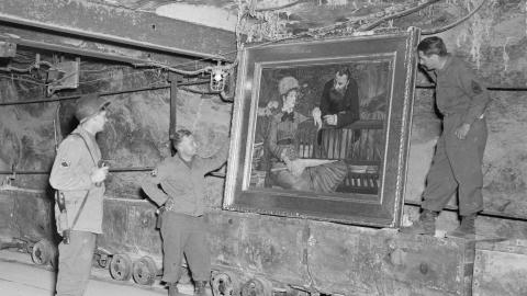 American soldiers looking at Manet's 'Wintergarden' recovered from Merkers Mine