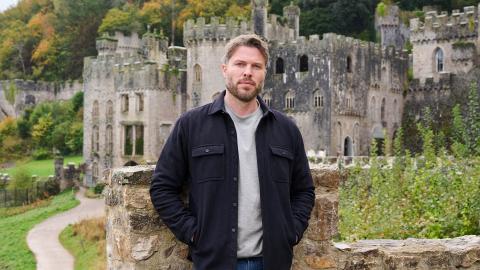 Rick Edwards standing in front of Gwrych Castle